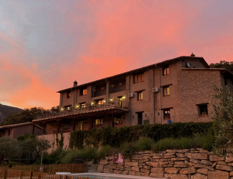 Traditional stone hotel in Rodellar at sunset